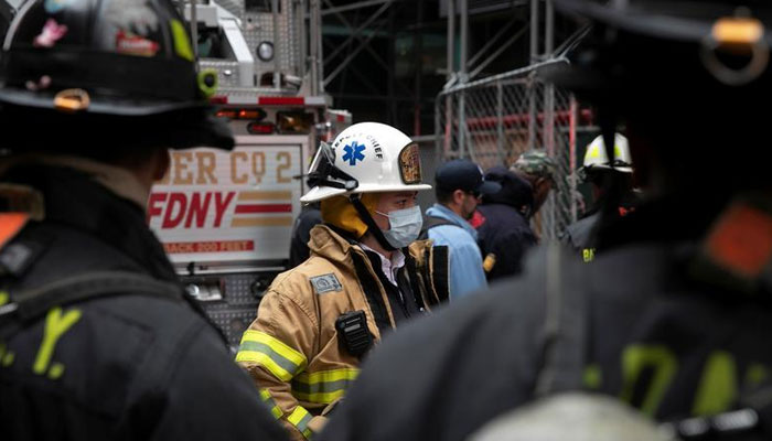 Firefighters stand by outside where a fire broke out in a Times Square hotel under construction in Manhattan in New York City, New York, US. — Reuters/File