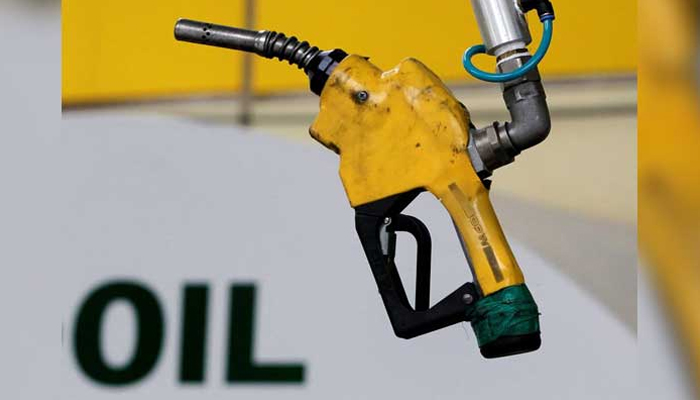 In this file photograph, a gas pump is seen hanging from the ceiling at a petrol station. — Reuters/File