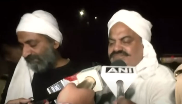 Former Indian politician Atiq Ahmed (right) and his brother Ashraf while talking to the media moments before they were attacked on April 16, 2023. — Screengrab/ANI