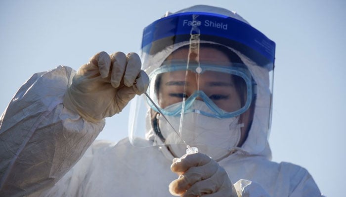 A member of the medical personnel works at a coronavirus disease (COVID-19) testing site which is temporarily set up at a railway station in Seoul, South Korea. — Reuters/File