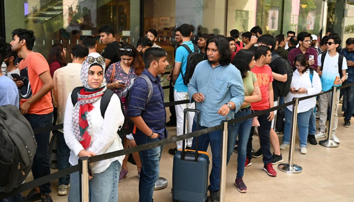 People queue outside Indias first Apple store ahead of its Tuesday opening in Mumbai which was inaugurated on April 18, 2023. — AFP