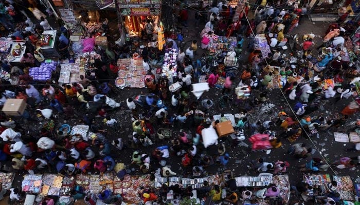 People shop at a crowded market in the old quarters of Delhi, India, October 11, 2022. — Reuters