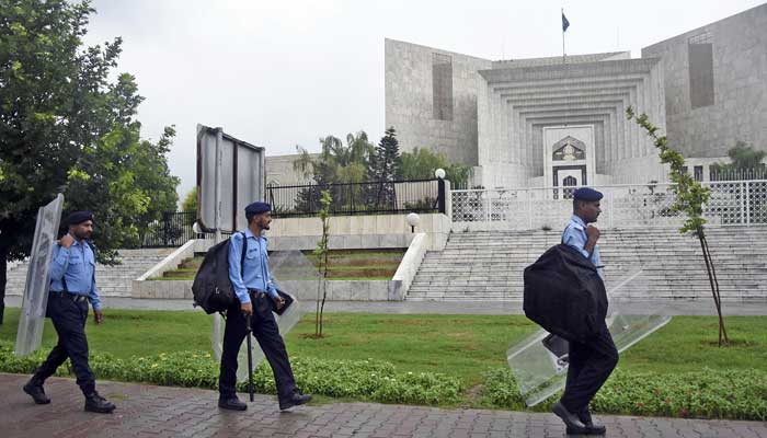 Police personnel walk outside Supreme Court in Islamabad on July 25, 2023. — Online