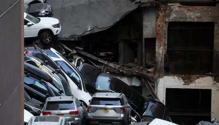 Cars seen tumbled in the debris of collapsed garage building in this file photo. — Reuters