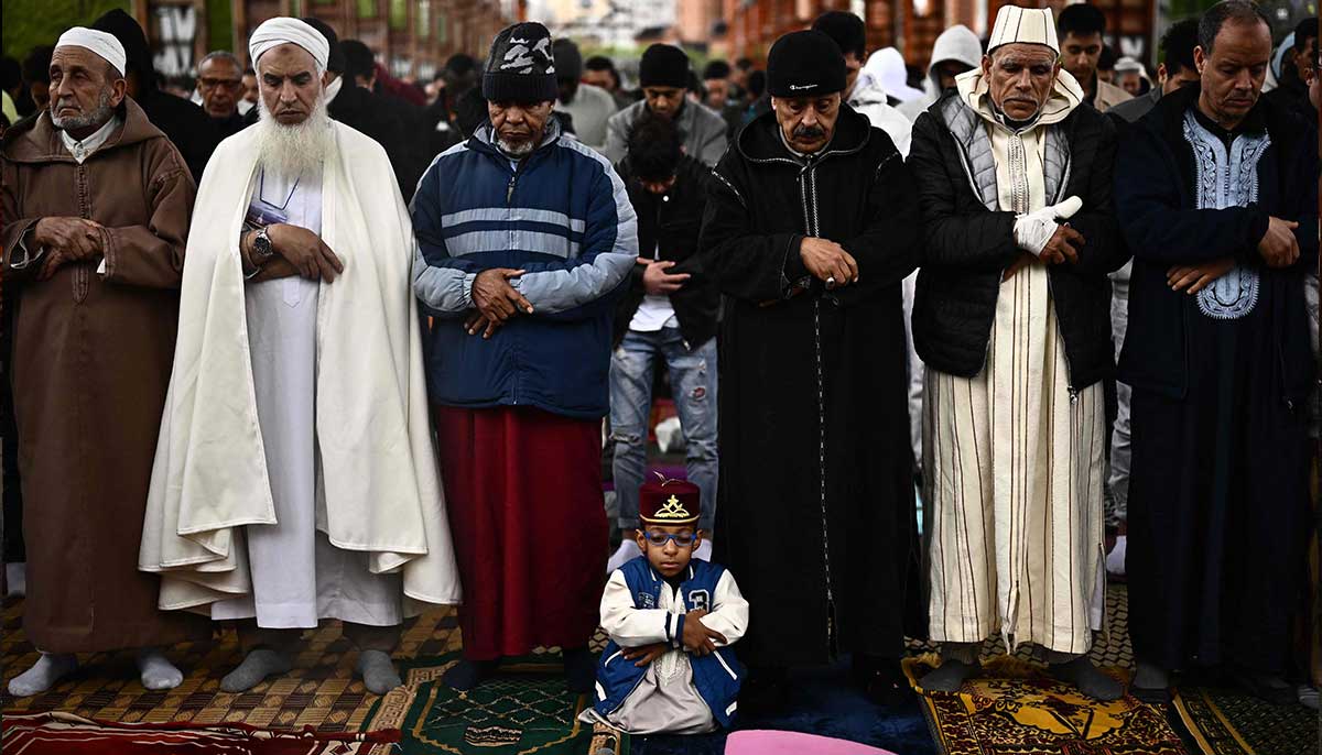 People pray on the first day of Eid ul Fitr at the industrial wasteland of Parco Dora in Turin on April 21, 2023.