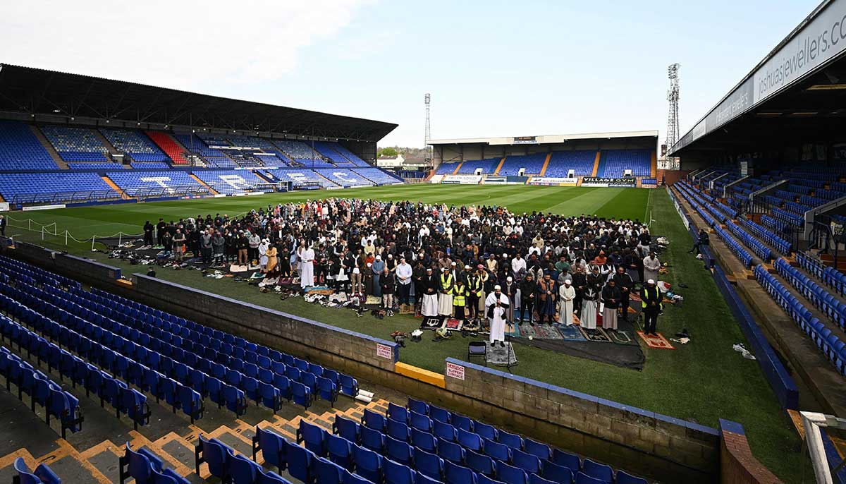 Muslims pray on the first day of Eid ul Fitr on the pitch at Tranmere Rovers Prenton Park stadium in Birkenhead, northwest England, on April 21, 2023.