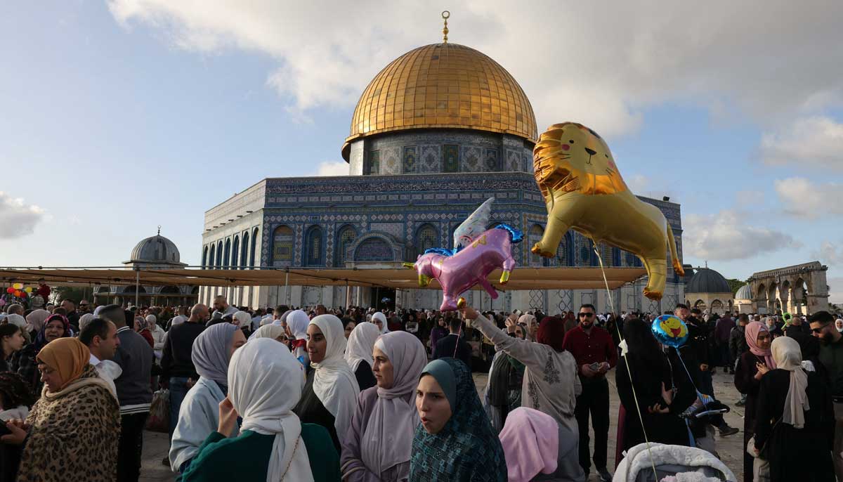 Muslim worshippers gather after the morning prayer on the first day of Eid ul Fitr outside the Dome of the Rock at the Al-Aqsa mosques complex in the Old City of Jerusalem on April 21, 2023.