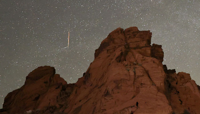 A meteor streaks above sandstone formations as the Earth passes through the debris trails of a broken comet called 73P/Schwassmann-Wachmann, or SW3, producing a never-before-seen meteor shower called the Tau Herculids in the Valley of Fire State Park, Nevada. — AFP/File