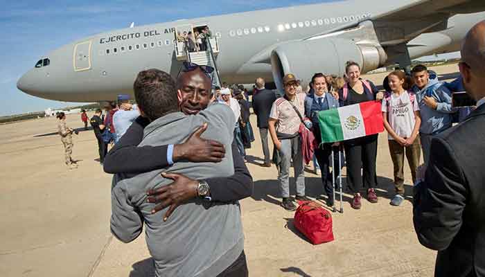 An evacuee is embraced after disembarking from a Spanish Air and Space Force plane at Torrejon de Ardoz Airbase, Spain April 24, 2023. — Reuters