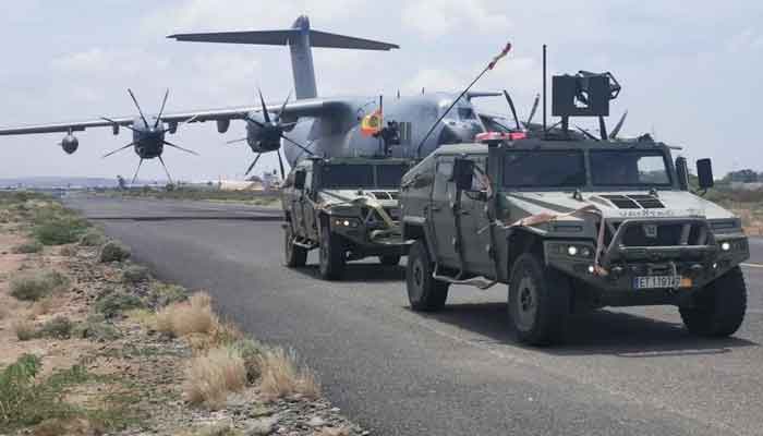 Spanish military plane and military vehicles are seen departing on tarmac as Spanish diplomatic personnel and citizens are evacuated, in Khartoum, Sudan, April 23. — Reuters