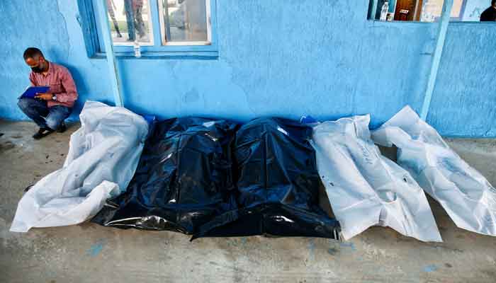 Bags with bodies of migrants, whose boats sank at the Mediterranean Sea, lie on the floor, in Garaboli, Libya April 25, 2023. —Reuters