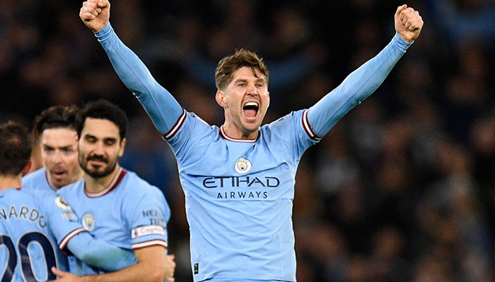 Manchester Citys English defender John Stones (R) celebrates scoring the team´s second goal during the English Premier League football match between Manchester City and Arsenal at the Etihad Stadium in Manchester, north west England, on April 26, 2023. AFP