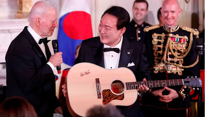 US President Joe Biden gifts a guitar signed by artist Don McLean to South Koreas President Yoon Suk Yeol at an official State Dinner, during Yoon Suk Yeols visit, at the White House in Washington, US on April 26, 2023. — Reuters