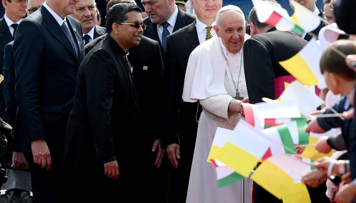 Pope Francis (R) is greeted by well-wishers after he arrived on April 28, 2023, at the Liszt Ferenc airport in Budapest. — — AFP