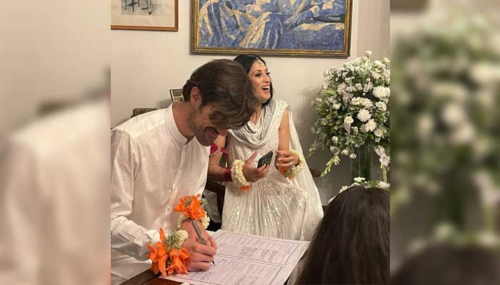 Graham (Gibran) signs the marriage contract while Fatima Bhutto smiles in the background. — Twitter/@fbhutto