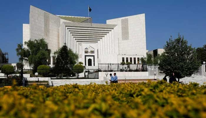 Policemen walk past the Supreme Court building. — Reuters/File