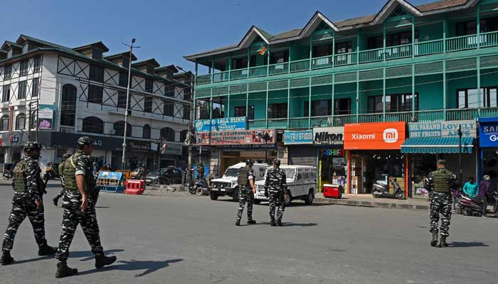 Indian paramilitary troopers patrol along a street in Srinagar on October 4, 2022, during India´s Home Minister Amit Shah´s visit to Jammu and Kashmir. — AFP