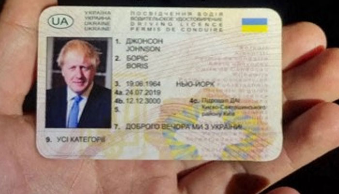 This image taken from the Instagram account of Netherlands’s Police Groningen Centrum on May 1, 2023, shows an official holding a Ukranian driving licence featuring an image of former British Prime Minister Boris Johnson, in Groningen. — AFP