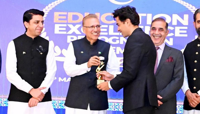 President Arif Alvi (second left) confers award on education activist Shehzad Roy (right). — Provided