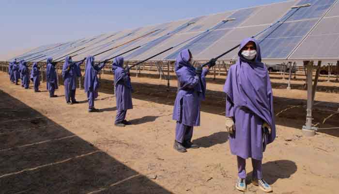 A group of female workers who are part of the solar panels cleaning team at work at the Thar Block-1 Integrated Coal Mine Power Project. — Provided