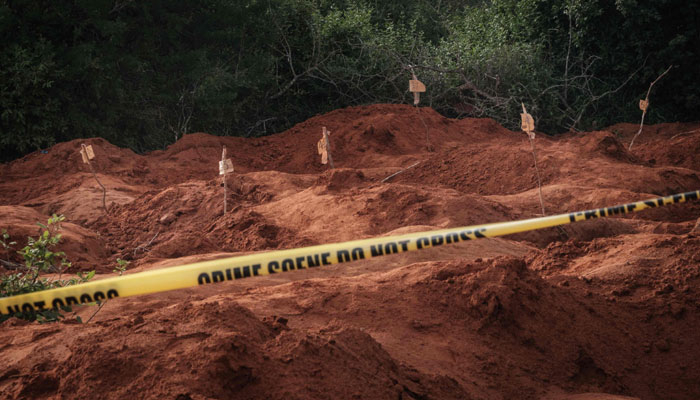 This file photo shows dug holes seen after exhuming bodies at the mass-grave site in Shakahola, outside the coastal town of Malindi. — AFP/File