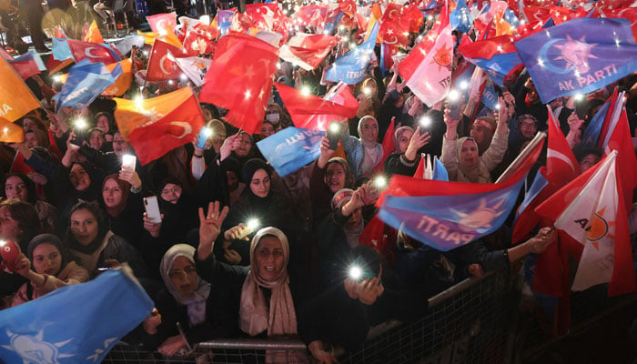 Turkish President Tayyip Erdogan supporters wave flags outside the AK Party headquarters after polls closed in Turkeys presidential and parliamentary elections in Ankara, Turkey May 15, 2023. — AFP