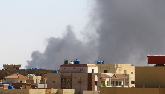 Smoke billows in the distance in Khartoum amid ongoing fighting between the forces of two rival generals, on May 15, 2023. — AFP