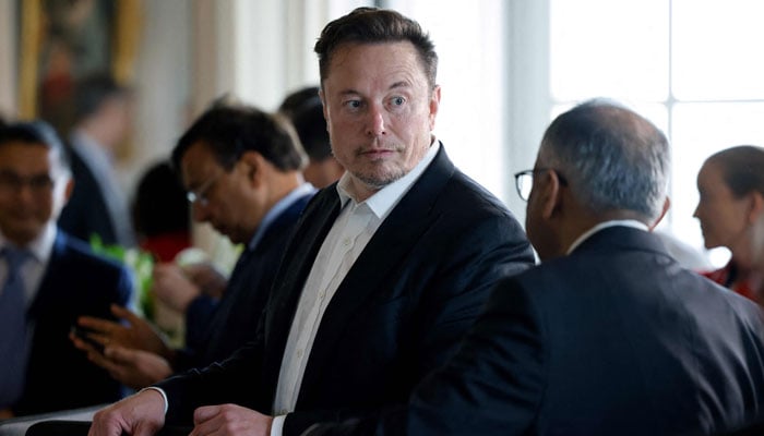 Tech billionaire, Elon Musk talks to another CEO before a roundtable during the 6th edition of the Choose France Summit at the Chateau de Versailles, outside Paris on May 15, 2023. — AFP