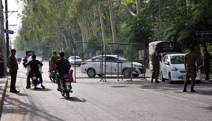 Police personnel are searching commuters at Sundar Das Road near Zaman Park in Lahore on Wednesday, May 17, 2023. — PPI