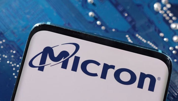 A smartphone with a displayed Micron logo is placed on a computer motherboard in this illustration. — Reuters/File