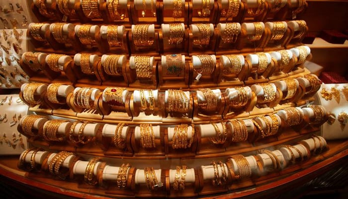 Sets of gold bangles are displayed in a showcase of a showroom selling bridal jewellery in Peshawar, May 9, 2018. — Reuters