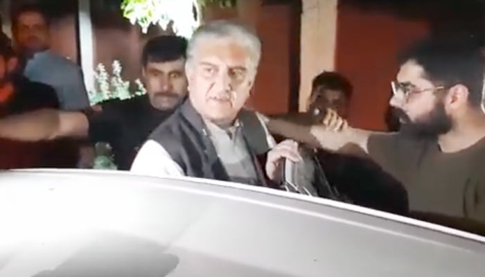 PTI Vice Chairman Shah Mahmood Qureshi outside Adiala Jail as he gets into a police vehicle in Rawalpindi, on May 23, 2023, in this still taken from a video. — Geo News