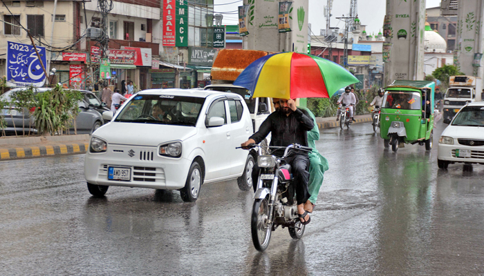 Motorists are on their way on the Murree road during rainy weather in Rawalpindi on May 29, 2023. — Online