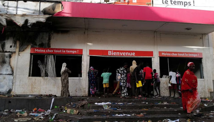 Onlookers take stock of the damage of a ransacked supermarket Auchan, after Senegal opposition leader Ousmane Sonko was sentenced to prison in Dakar, Senegal June 3, 2023. — Reuters