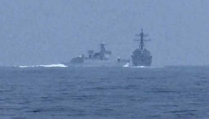 A Peoples Republic of China warship, identified by the US Indo-Pacific Command as PRC LY 132, crosses the path of U.S. Navy destroyer USS Chung-Hoon as it was transiting the Taiwan Strait with the Royal Canadian Navy frigate HMCS Montreal June 3, 2023, in a still image from video.—Reuters