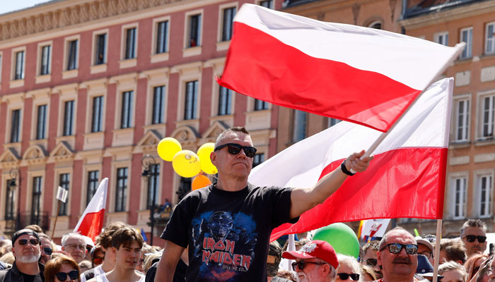 Protesters wave the Polish flag during an anti-government demonstration organized by the opposition in Warsaw on June 4, 2023. — AFP