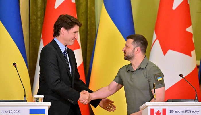 Ukrainian President Zelensky (R) and Canadian PM Justin Trudeau shake hands during a press conference in Kyiv on June 10, 2023. — AFP