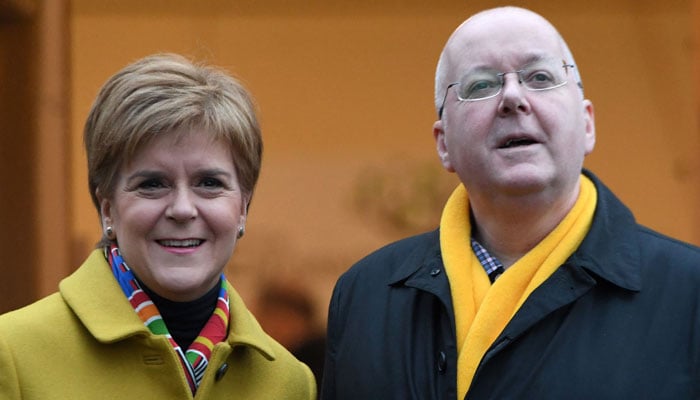 Scotlands former First Minister and leader of the SNP, Nicola Sturgeon, stands with her husband Peter Murrell outside a Polling Station in Glasgow, Scotland.