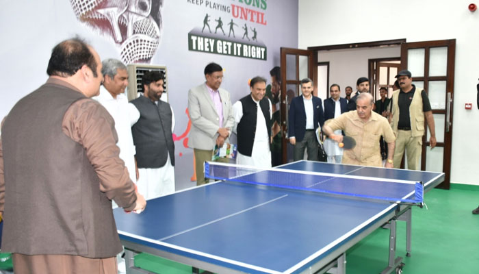 Prime Minister Shehbaz Sharif plays badminton at Sabzazar Sports Complex in Lahore on June 11, 2023. — APP