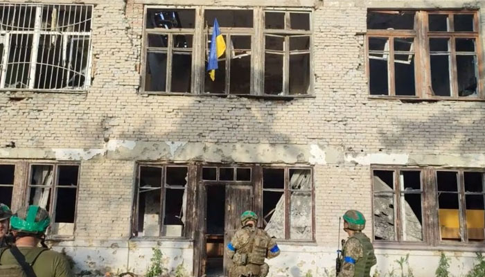 Ukrainian soldiers place a Ukrainian flag at a building, during an operation that claims to liberate the first village amid a counter-offensive, in a location given as Blahodatne, Donetsk Region, Ukraine, in this screengrab taken from a handout video released on June 11, 2023.—Reuters