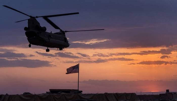 A US Army CH-47 Chinook helicopter takes off at sunset while transporting American troops out of a remote combat outpost in northeastern Syria. — AFP/File
