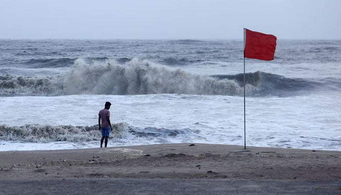 A lifeguard patrols Juhu beach, during a red flag alert due to rough seas caused by cyclone Biparjoy, in Mumbai, India, June 12, 2023. — Reuters