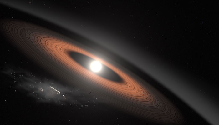 In this illustration, an asteroid (bottom left) breaks apart under the powerful gravity of LSPM J0207+3331, the oldest, coldest white dwarf known to be surrounded by a ring of dusty debris. — Nasa/File