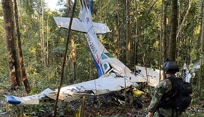 This picture shows a soldier standing next to the wreckage of an aircraft that crashed in the Colombian Amazon forest in the municipality of Solano, department of Caqueta, on May 19, 2023. — AFP
