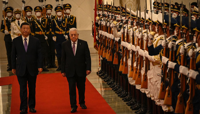 Chinas President Xi Jinping (left) and Palestinian President Mahmud Abbas attend a welcoming ceremony at the Great Hall of the People in Beijing. — AFP