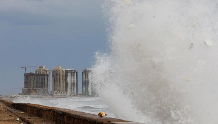 View of residential buildings as the rising waves splash, before the arrival of the cyclonic storm, Biparjoy, over the Arabian Sea, at Clifton Beach, in Karachi, June 13, 2023. — Reuters