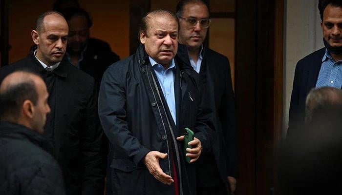 Former prime minister Nawaz Sharif (3L), brother of current Prime Minister Shehbaz Sharif, leaves a property in west London on May 11, 2022. — AFP