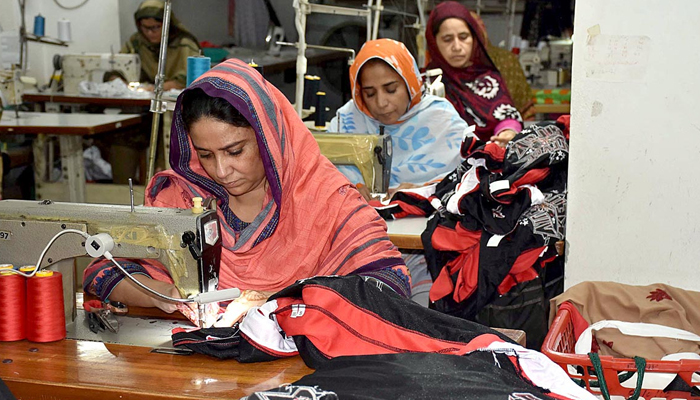 Women stitch export quality garments in a factory in Sialkot on October 12, 2022. — APP