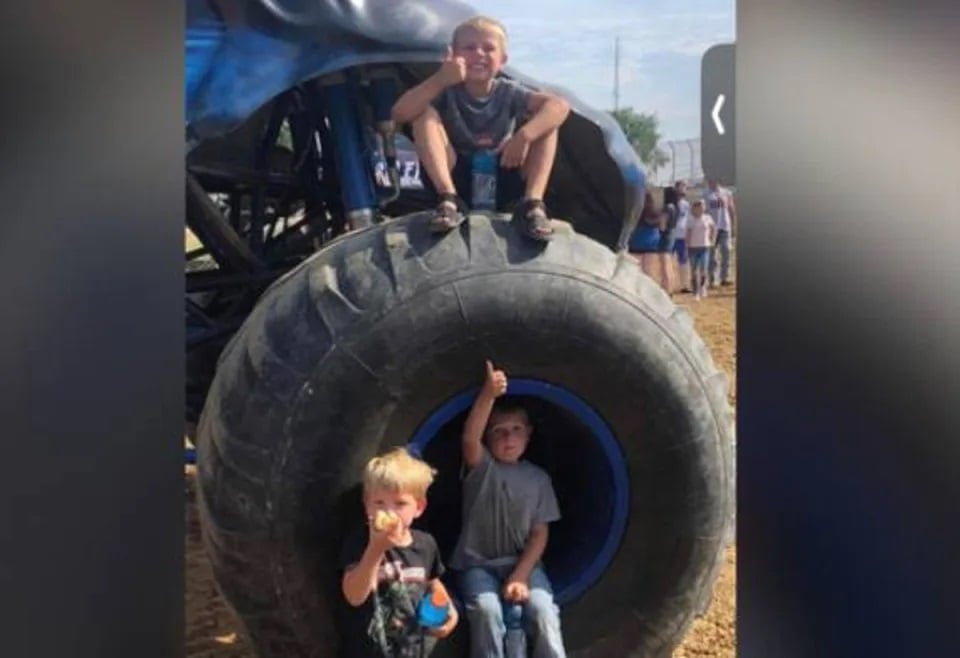 This screengrab from a YouTube video shows the children playing on a monster truck. —Screebgrab