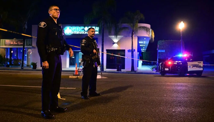 Police stand guard at a crime scene near the intersection of Garvey and Garfield Avenue in Monterey Park, US. — AFP/File